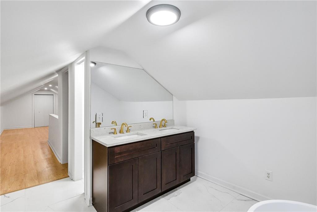1967 Browns Mill Road Southeast Atlanta, GA 30315 - Photo 28 of 35 a bathroom with a sink and mirror with toilet