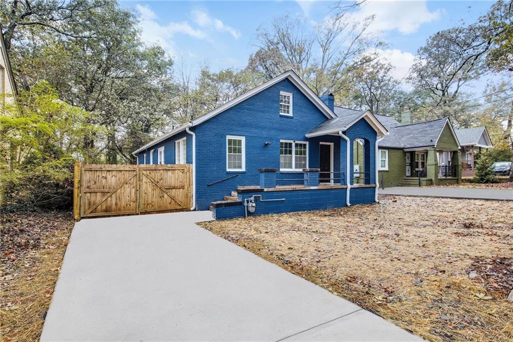 1967 Browns Mill Road Southeast Atlanta, GA 30315 - Photo 3 of 35 a front view of a house with yard and trees in the background