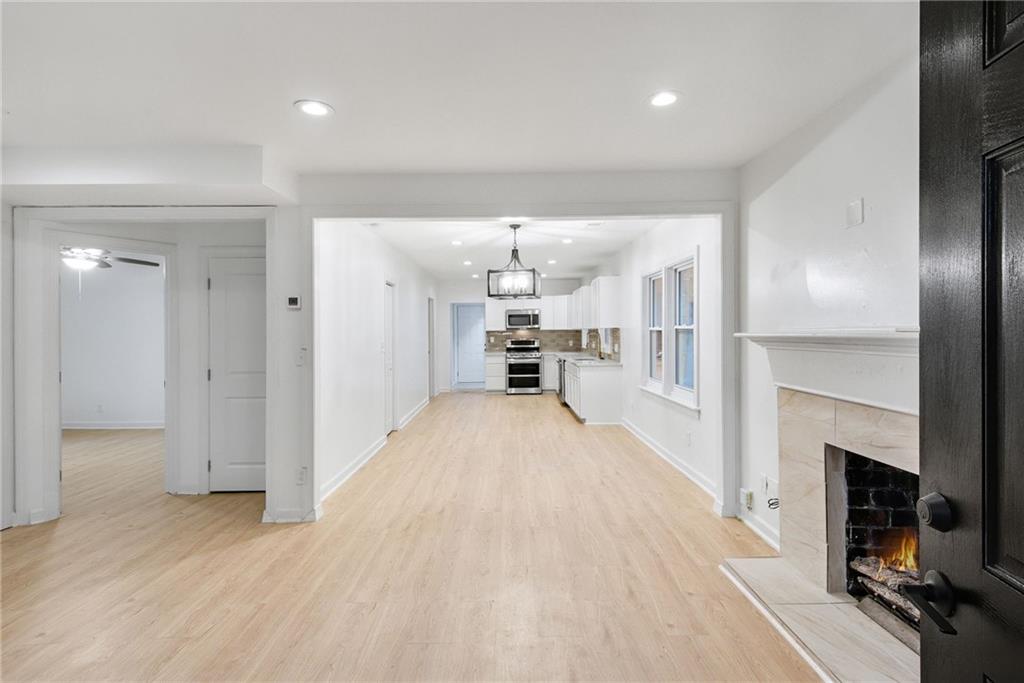 1967 Browns Mill Road Southeast Atlanta, GA 30315 - Photo 4 of 35 a view of a kitchen and a livingroom with a fireplace