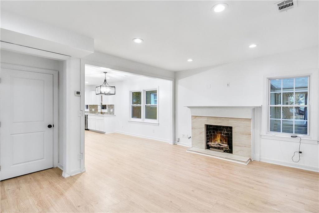 1967 Browns Mill Road Southeast Atlanta, GA 30315 - Photo 6 of 35 a view of an empty room with a window and fireplace