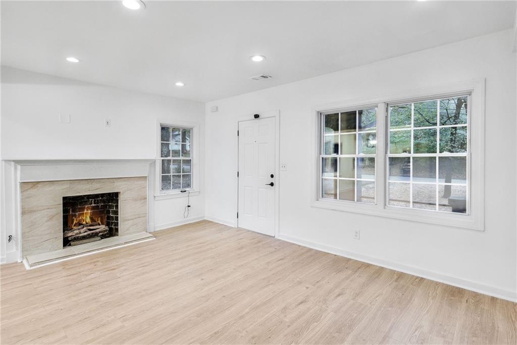 1967 Browns Mill Road Southeast Atlanta, GA 30315 - Photo 7 of 35 an empty room with windows and fireplace
