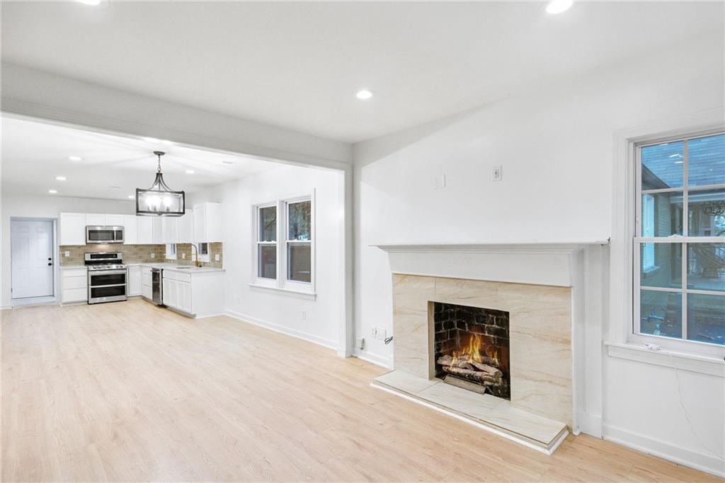 1967 Browns Mill Road Southeast Atlanta, GA 30315 - Photo 8 of 35 a view of a livingroom with furniture and a fireplace