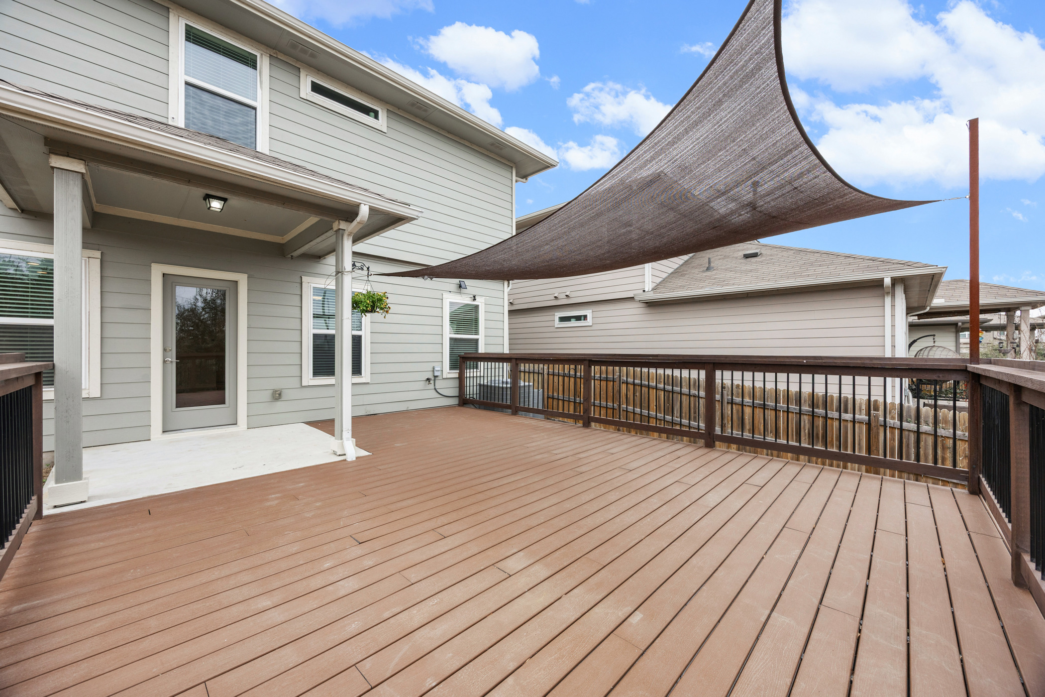 8324 Mimi Lane Austin, TX 78724 - Photo 29 of 40 Gorgeous Trex deck with freshly stained railing, and a shade sail for extra shade and style.
