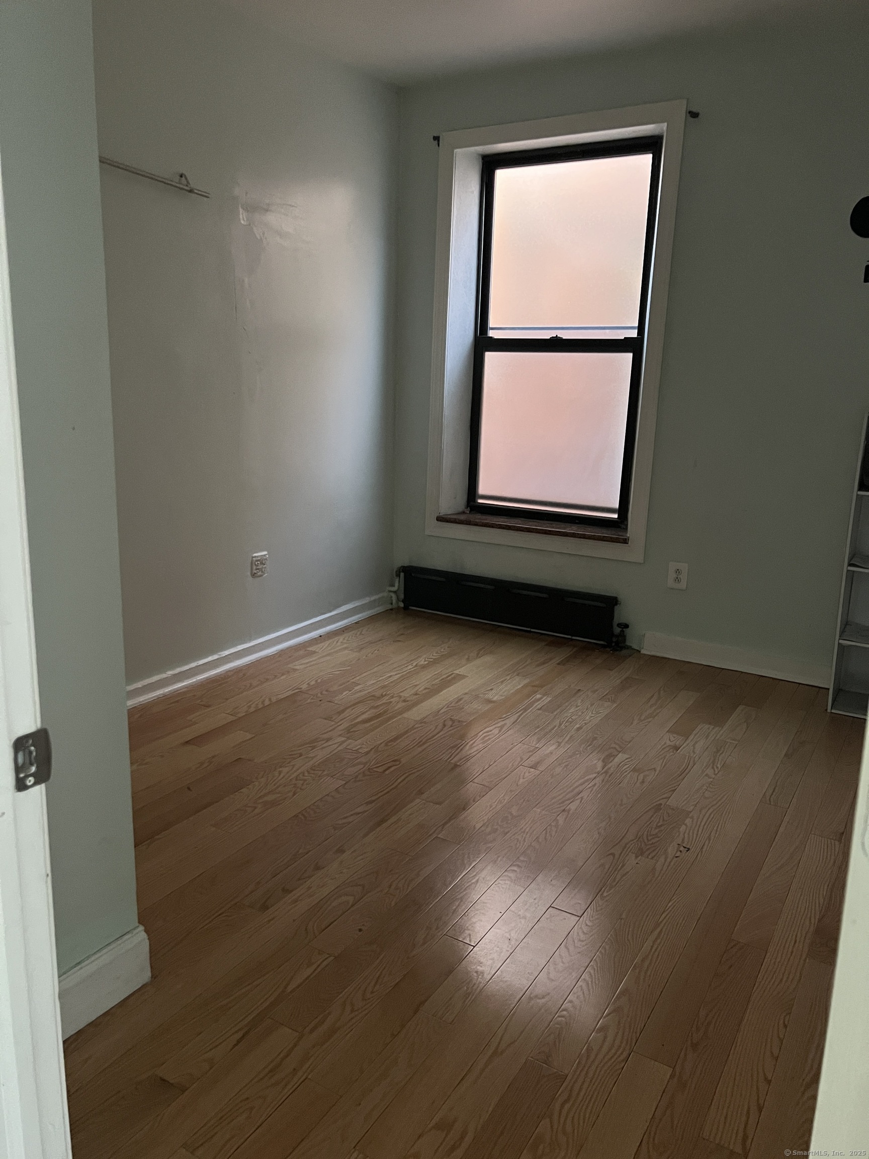546 Congress Avenue, Unit 1 New Haven, CT 06519 - Photo 8 of 14 an empty room with wooden floor and windows