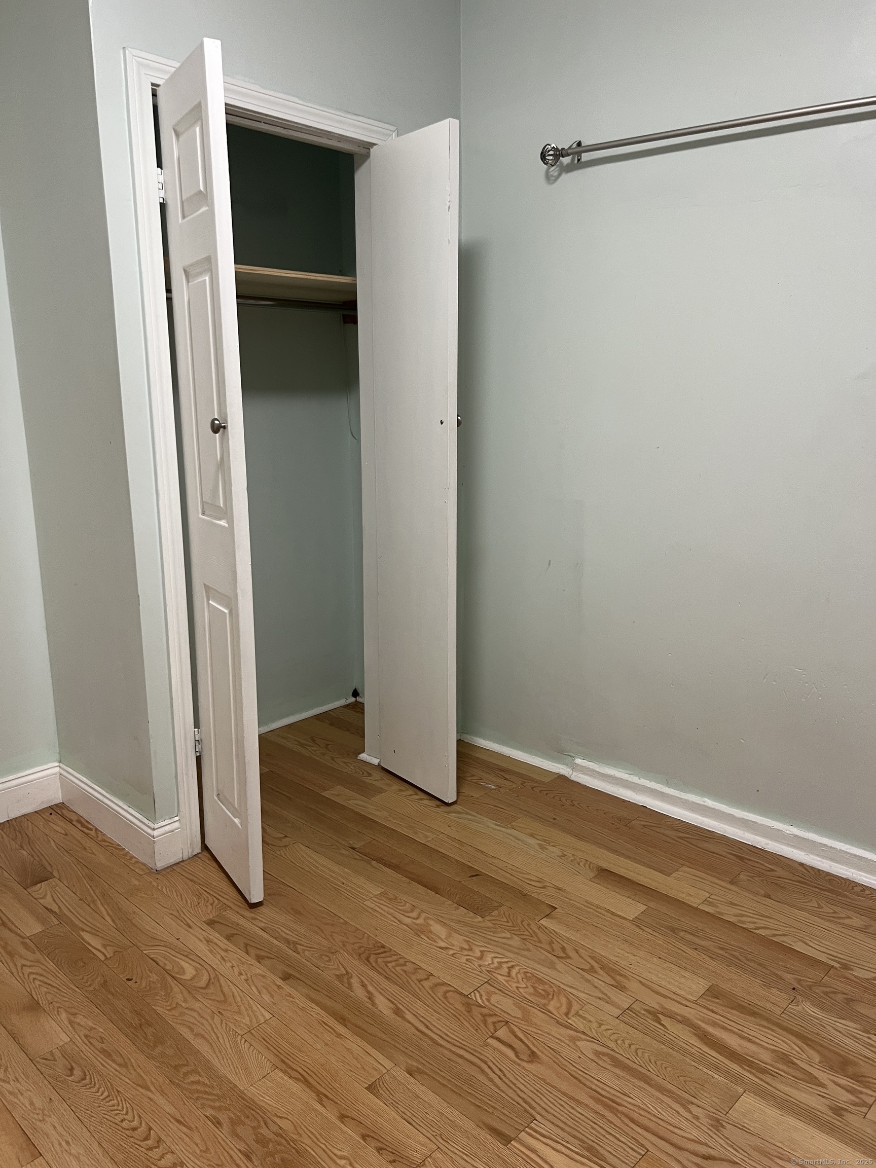 546 Congress Avenue, Unit 1 New Haven, CT 06519 - Photo 9 of 14 a view of an empty room with wooden floor and closet
