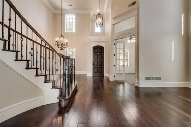 a view of entryway with wooden floor and stairs