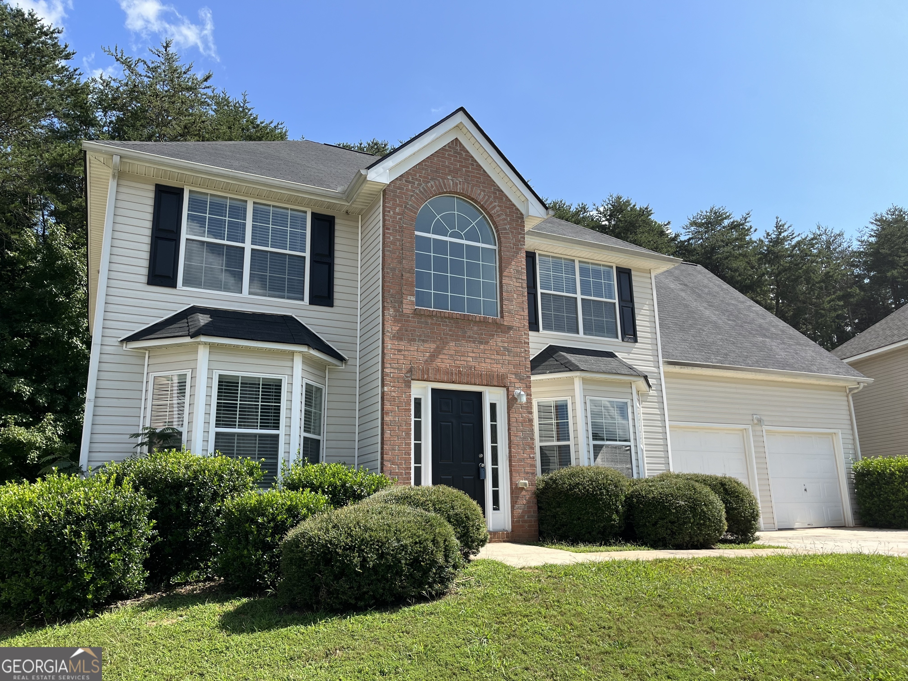 a front view of a house with a yard