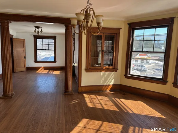 a view of an entryway with wooden floor and a window