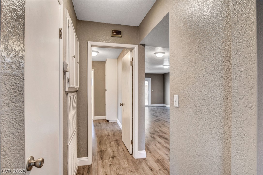 4367 South Mojave Road Las Vegas, NV 89121 - Photo 15 of 53 A well-lit hallway with durable wood flooring guides you through the inviting interior.