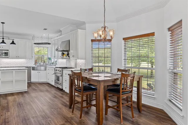 a view of a dining room with furniture windows and wooden floor