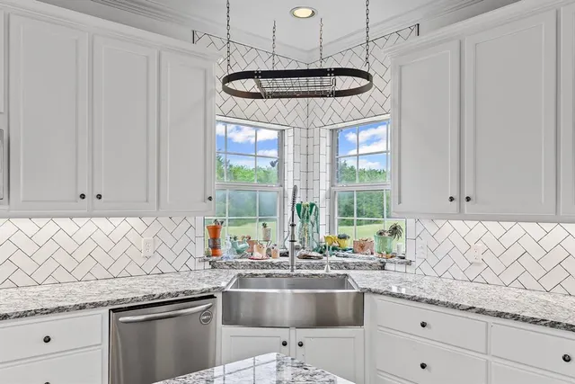 a kitchen with stainless steel appliances granite countertop a sink a stove and a granite counter tops
