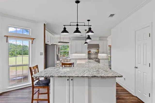 a kitchen with a table and chairs in it