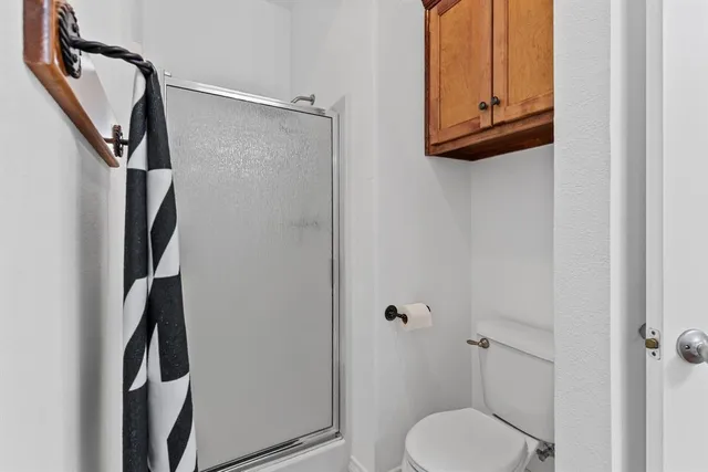 a bathroom with a toilet and a shower