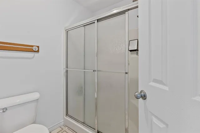 a bathroom with a shower and a toilet
