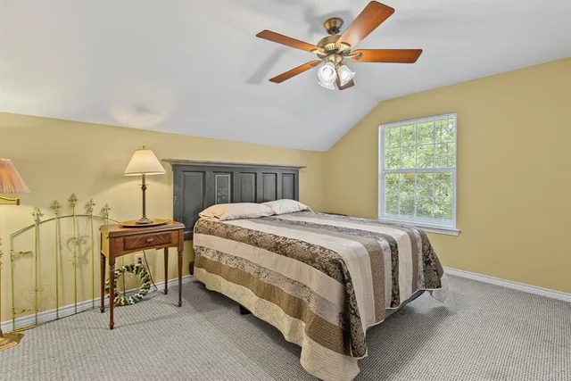 a bed sitting in a bedroom next to a window