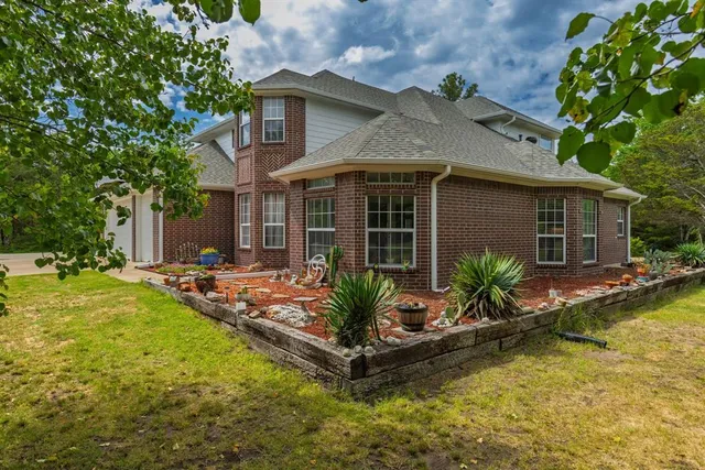 a view of a house with swimming pool and sitting area