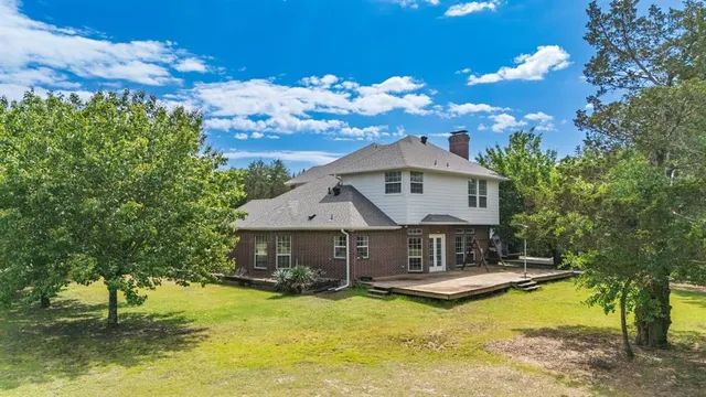a view of a house with swimming pool yard and front view of a house