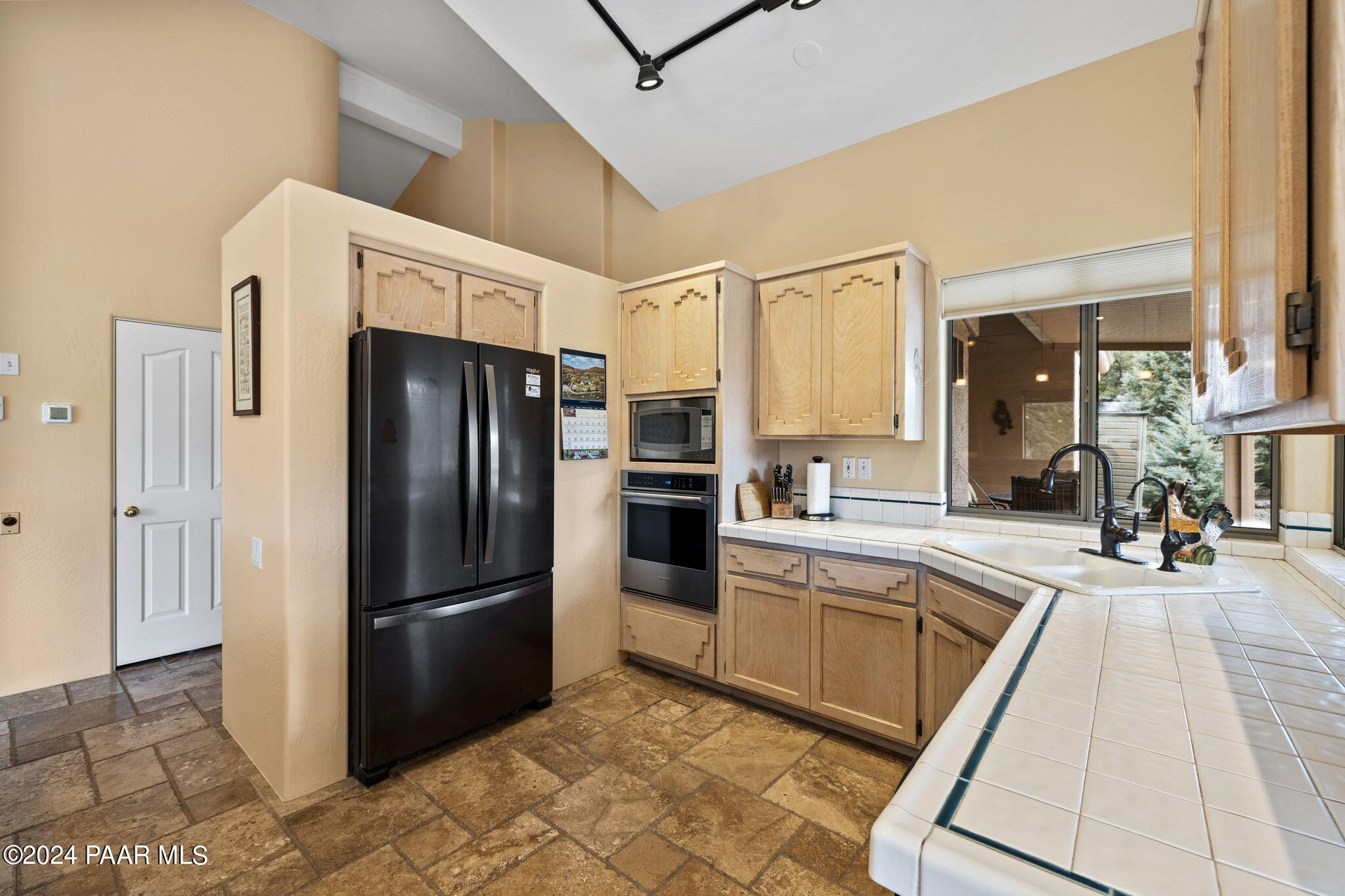 2147 West Post Oak Drive Prescott, AZ 86305 - Photo 14 of 59 a kitchen with granite countertop a refrigerator and a sink