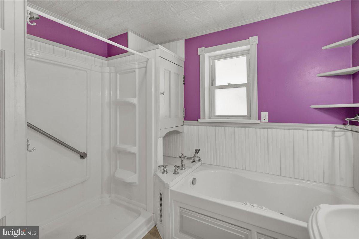 27 Woodland Road Reading, PA 19610 - Photo 17 of 34 a bathroom with a bathtub and a shower