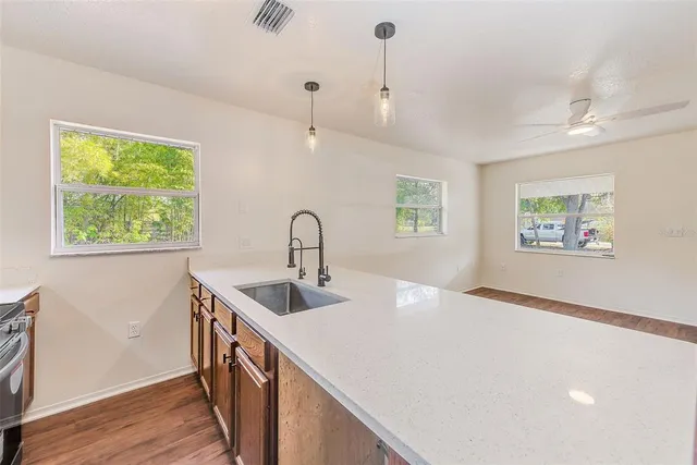 a kitchen with a sink a counter and cabinets