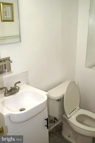 a white toilet sitting next to a bathroom sink