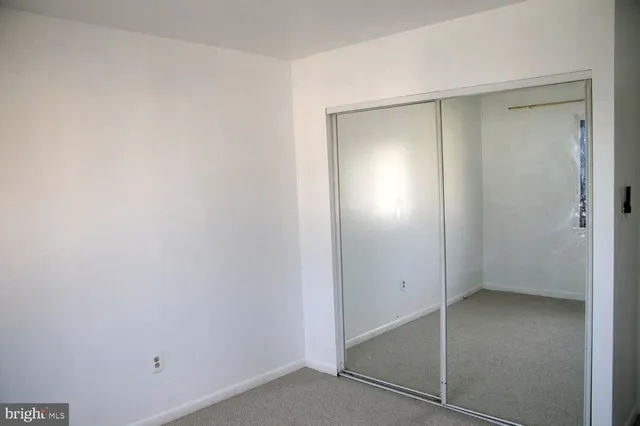 an empty room that has a mirror