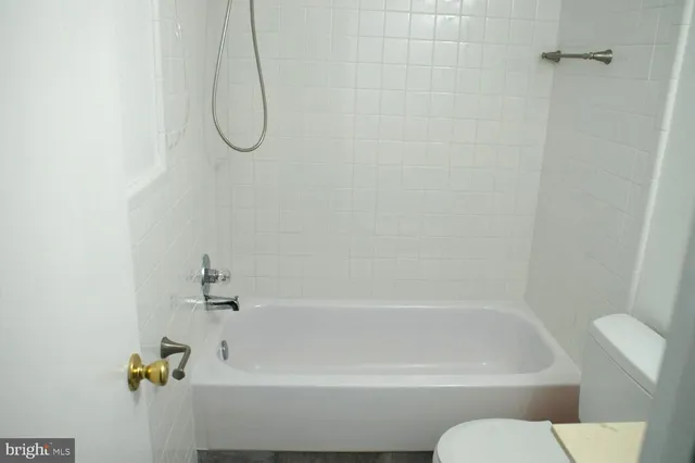 a bathroom with a shower and a bath tub