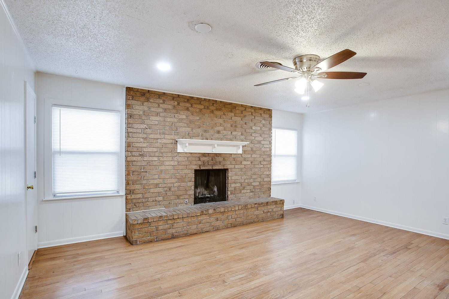 3414 32nd Street Lubbock, TX 79410 - Photo 3 of 11 a view of empty room with wooden floor and fan