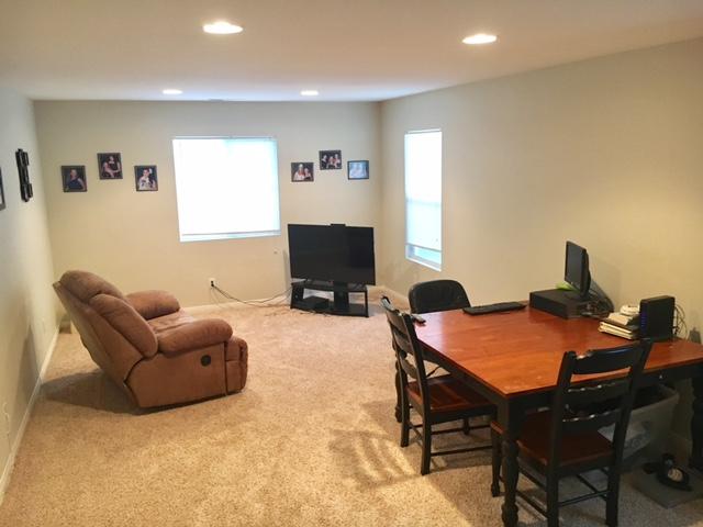 1844 Minter Way Lancaster, CA 93534 - Photo 11 of 15 a living room with furniture a flat screen tv and a window