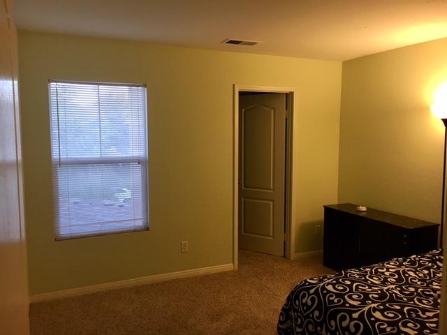 1844 Minter Way Lancaster, CA 93534 - Photo 12 of 15 a bedroom with a bed and cabinets