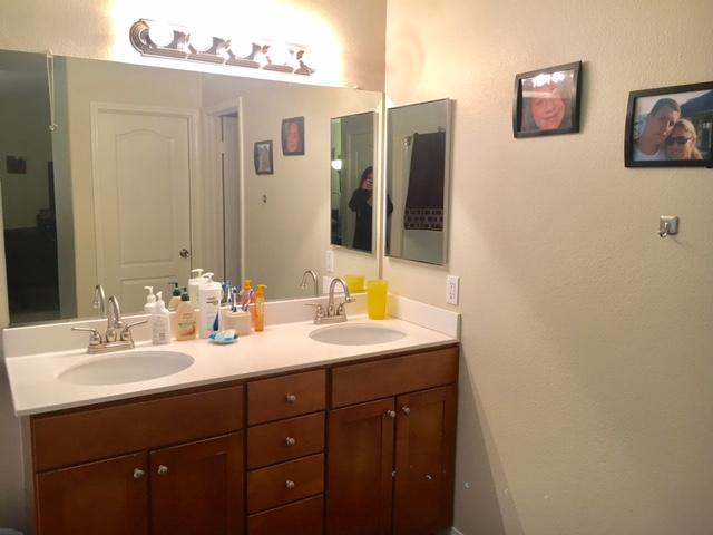 1844 Minter Way Lancaster, CA 93534 - Photo 15 of 15 a bathroom with a sink and a mirror