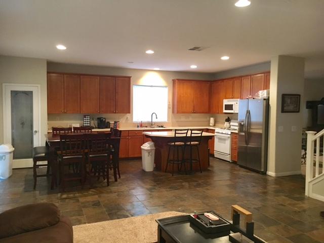 1844 Minter Way Lancaster, CA 93534 - Photo 2 of 15 a kitchen with a refrigerator and a stove top oven