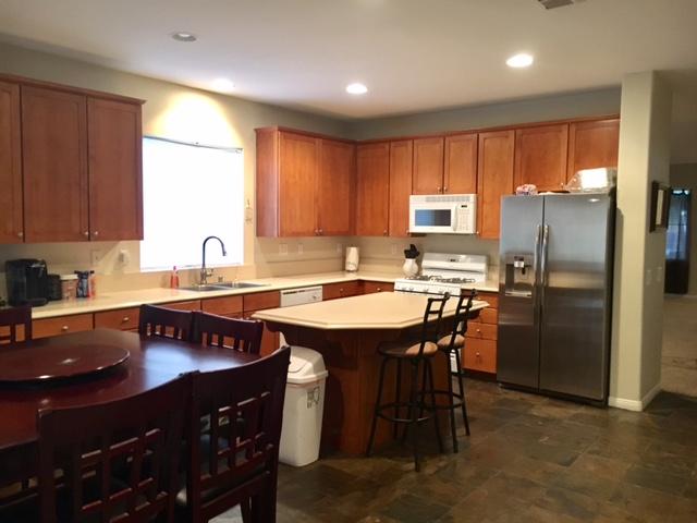 1844 Minter Way Lancaster, CA 93534 - Photo 3 of 15 a kitchen with stainless steel appliances granite countertop a sink stove and refrigerator