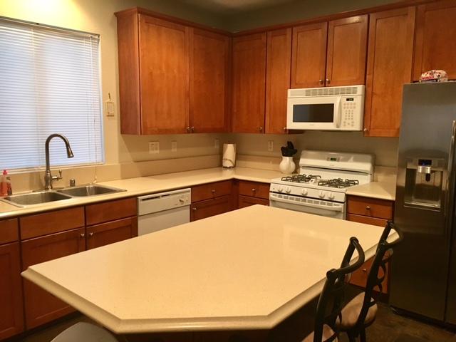 1844 Minter Way Lancaster, CA 93534 - Photo 5 of 15 a kitchen with a sink a stove and chairs