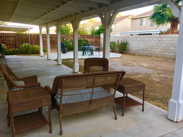 1844 Minter Way Lancaster, CA 93534 - Photo 10 of 15 a view of a patio with a table chairs and a backyard