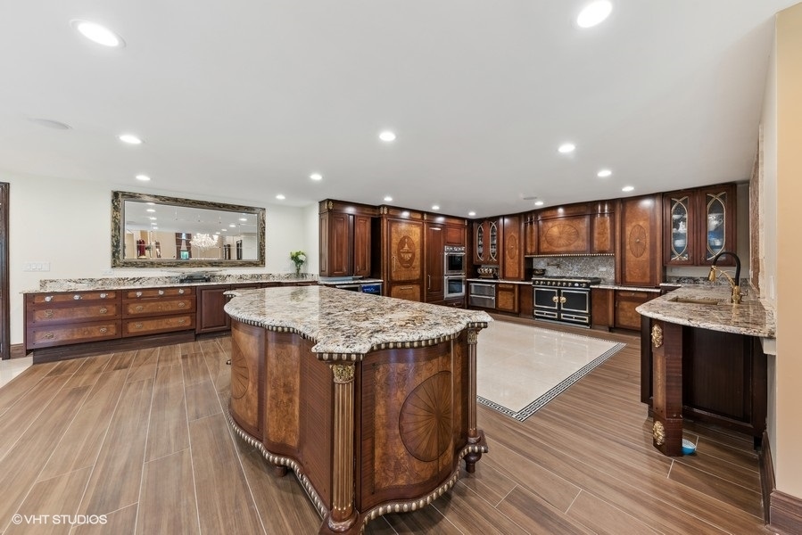 24575 Illinois Rte 59 Barrington, IL 60010 - Photo 11 of 60 a kitchen with stainless steel appliances kitchen island granite countertop a stove and a refrigerator