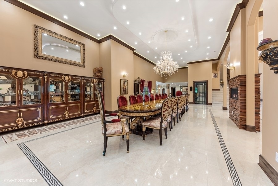 24575 Illinois Rte 59 Barrington, IL 60010 - Photo 13 of 60 a dining room with lots of wooden furniture and a chandelier