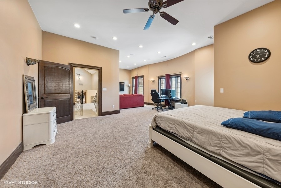 24575 Illinois Rte 59 Barrington, IL 60010 - Photo 27 of 60 a spacious bedroom with a bed and a chandelier