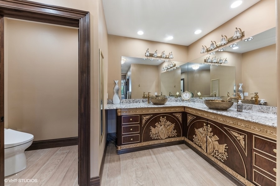24575 Illinois Rte 59 Barrington, IL 60010 - Photo 32 of 60 a spacious bathroom with a sink a toilet a mirror and vanity