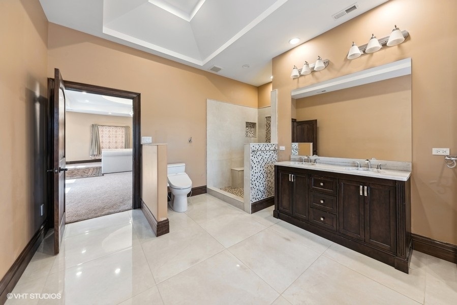 24575 Illinois Rte 59 Barrington, IL 60010 - Photo 33 of 60 a spacious bathroom with a granite countertop sink mirror and a toilet