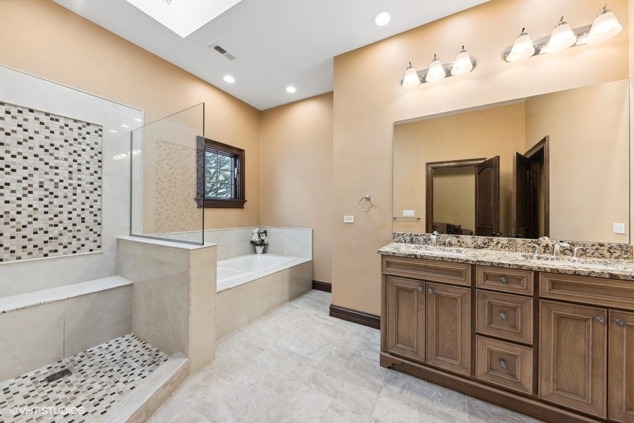 24575 Illinois Rte 59 Barrington, IL 60010 - Photo 34 of 60 a bathroom with a tub a sink and a mirror