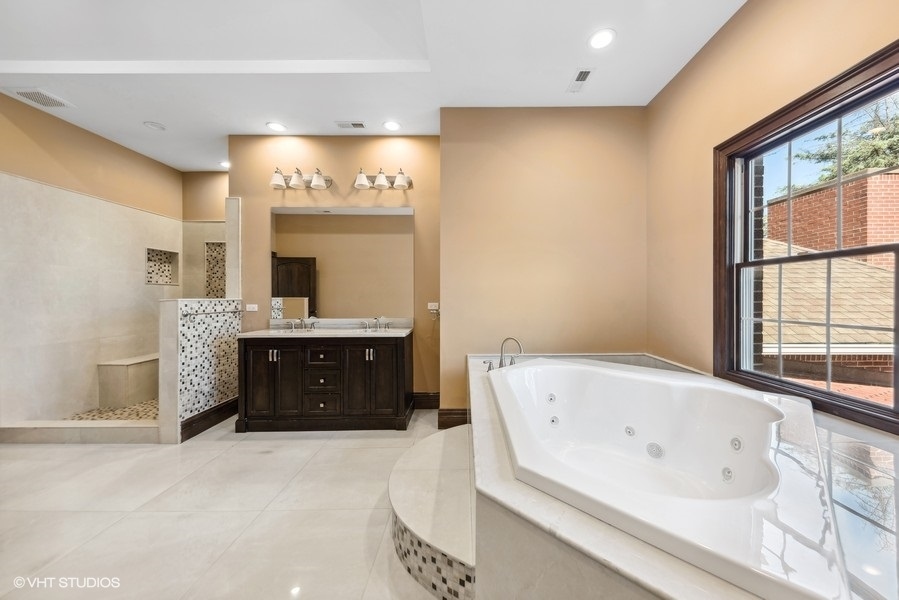 24575 Illinois Rte 59 Barrington, IL 60010 - Photo 35 of 60 a spacious bathroom with a tub sink and mirror