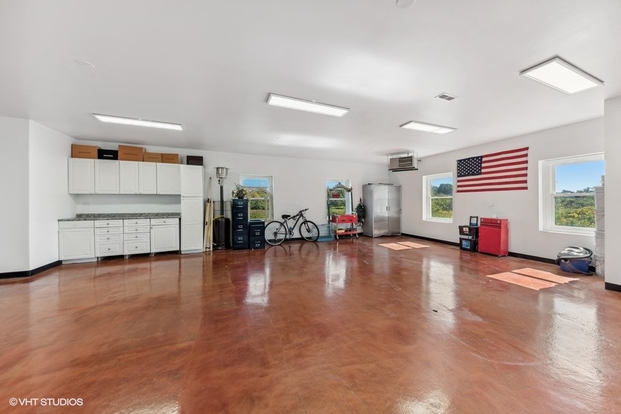 24575 Illinois Rte 59 Barrington, IL 60010 - Photo 38 of 60 a view of a living room a kitchen with a sink and a stove top oven