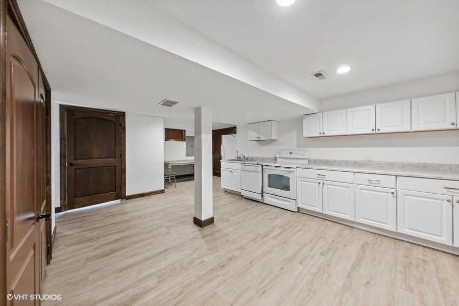 24575 Illinois Rte 59 Barrington, IL 60010 - Photo 40 of 60 a kitchen with white cabinets and white appliances