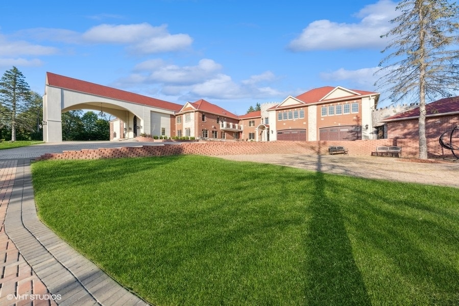24575 Illinois Rte 59 Barrington, IL 60010 - Photo 50 of 60 a front view of a house with a yard fire pit and outdoor seating