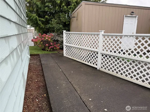 a view of a patio with table and chairs potted plants with wooden fence