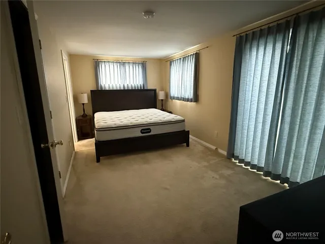 a bedroom with a bed and chair