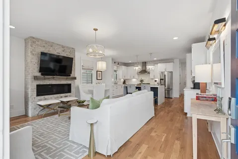 a living room with fireplace furniture and a flat screen tv
