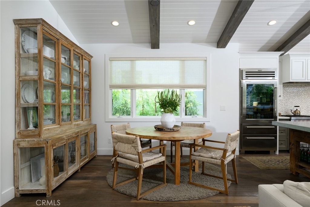 519 Signal Road Newport Beach, CA 92663 - Photo 11 of 40 a dining room with furniture large windows and a chandelier