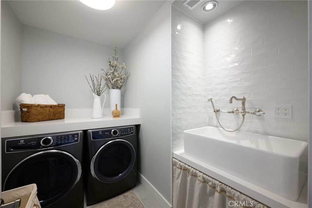 519 Signal Road Newport Beach, CA 92663 - Photo 27 of 40 a bathroom with a sink and a washer dryer